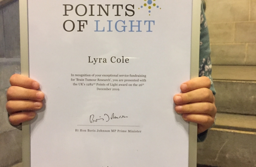 Lyra with her certificate from Boris Johnson 